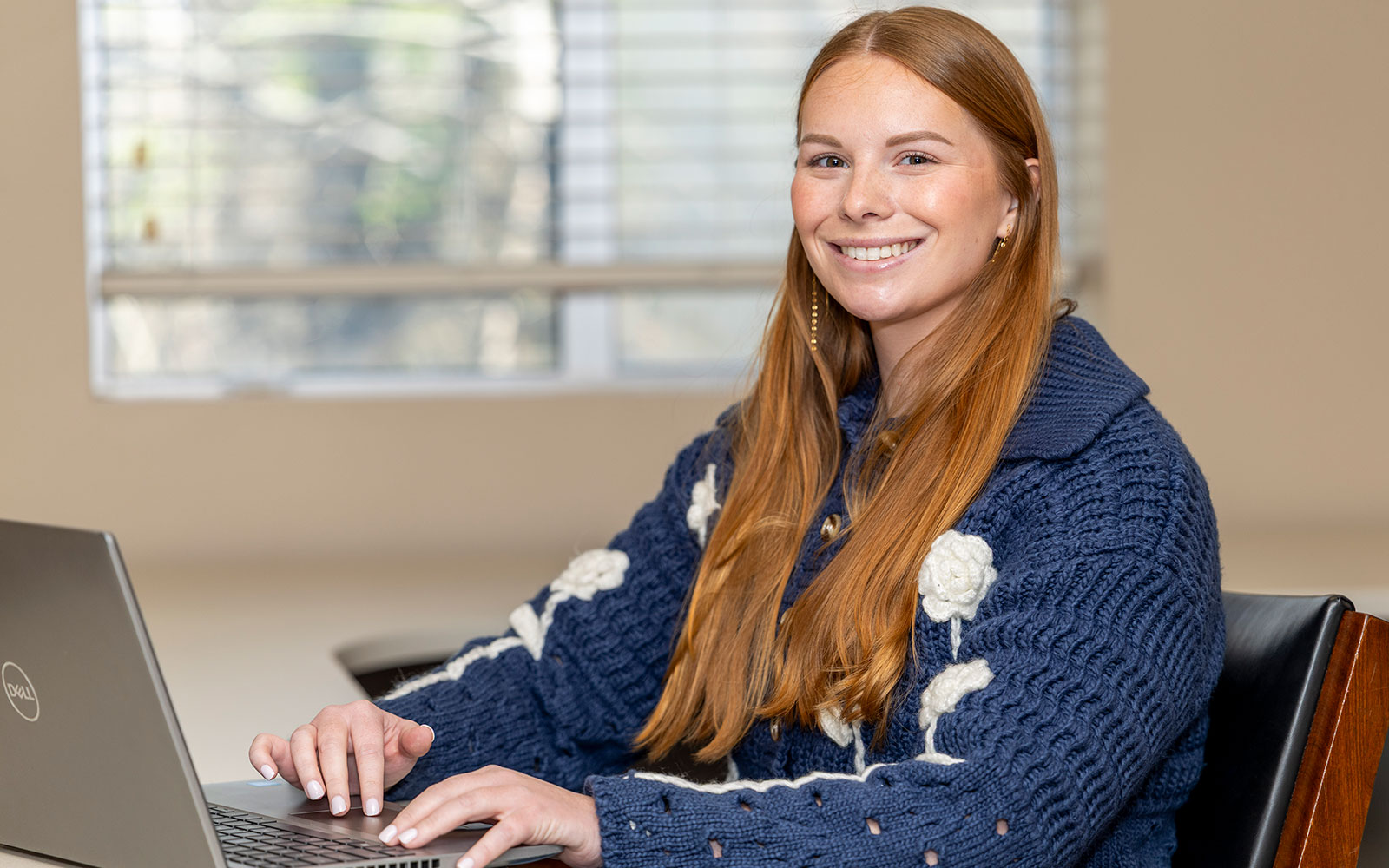 girl sitting at a desk with a computer